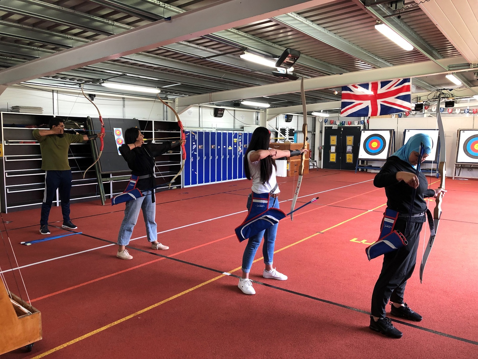 Members of the Muslim Sports Foundation try out archery at Archery GB headquarters in Lilleshall