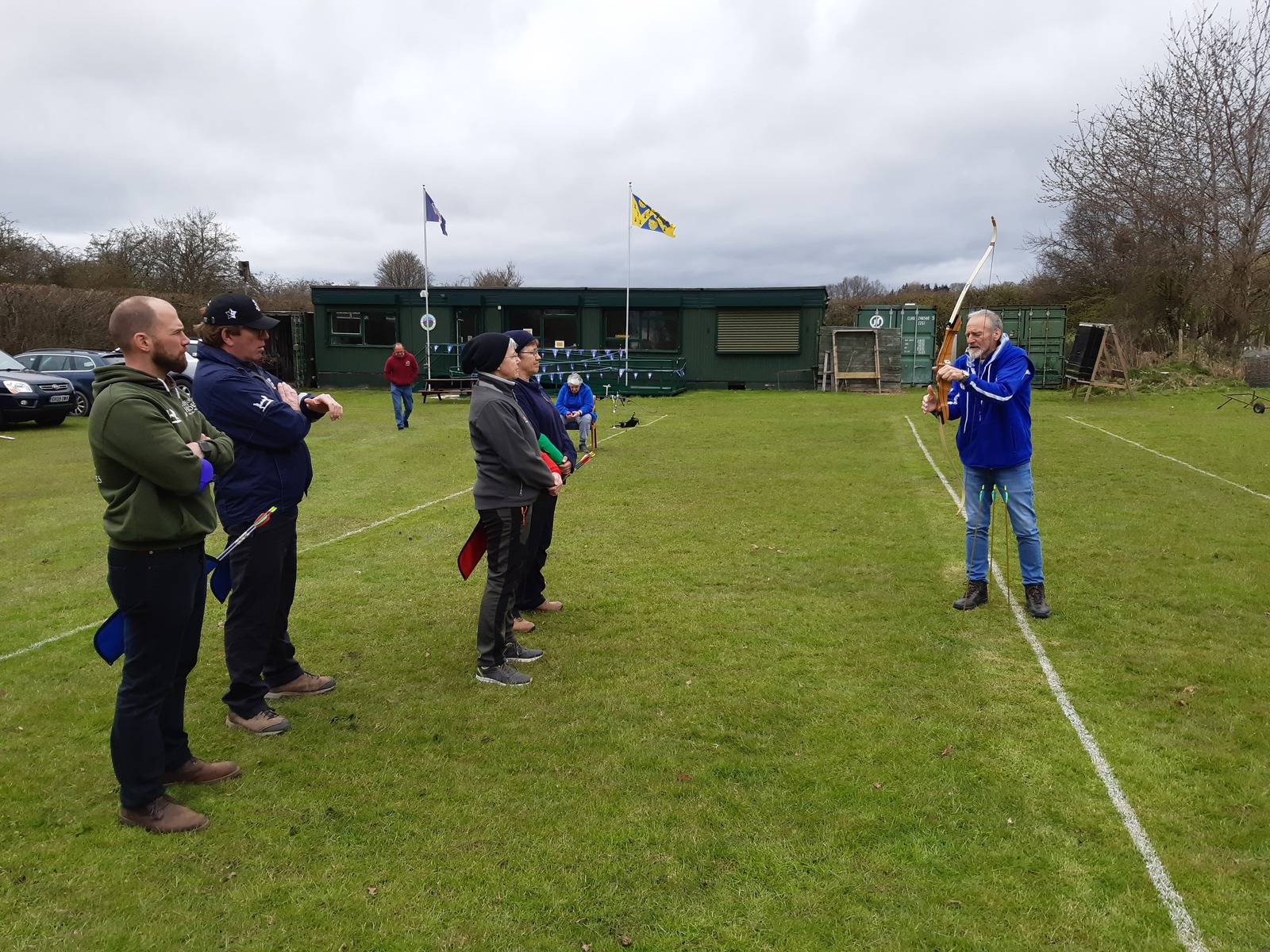 Coach and archers at a range 