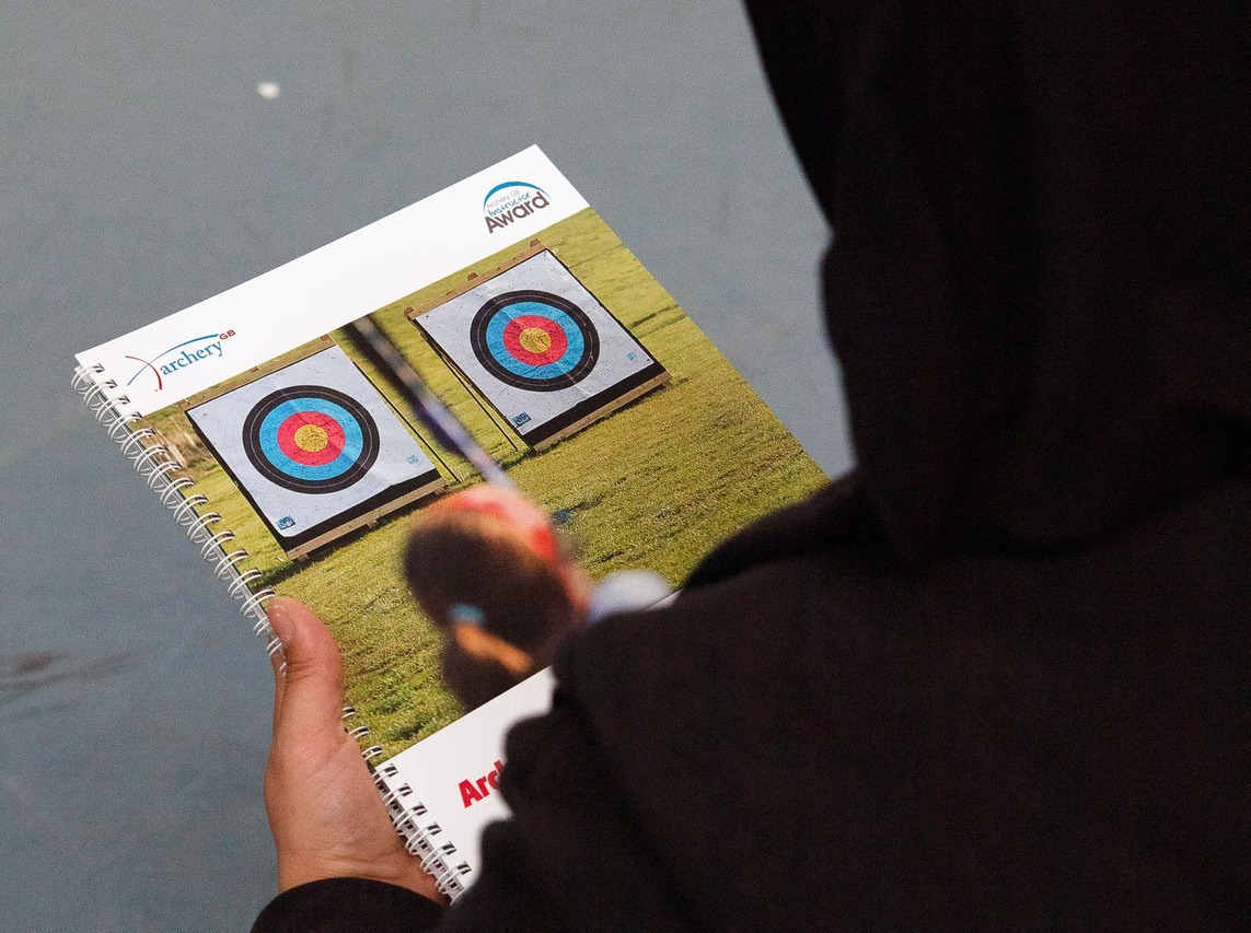 Course participant looking at the Archery GB Instructor Award handbook