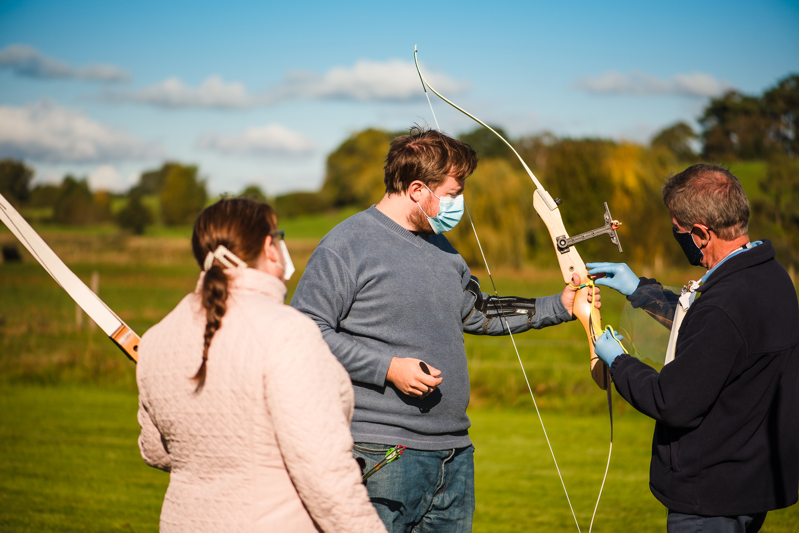 Archers and coach wearing masks