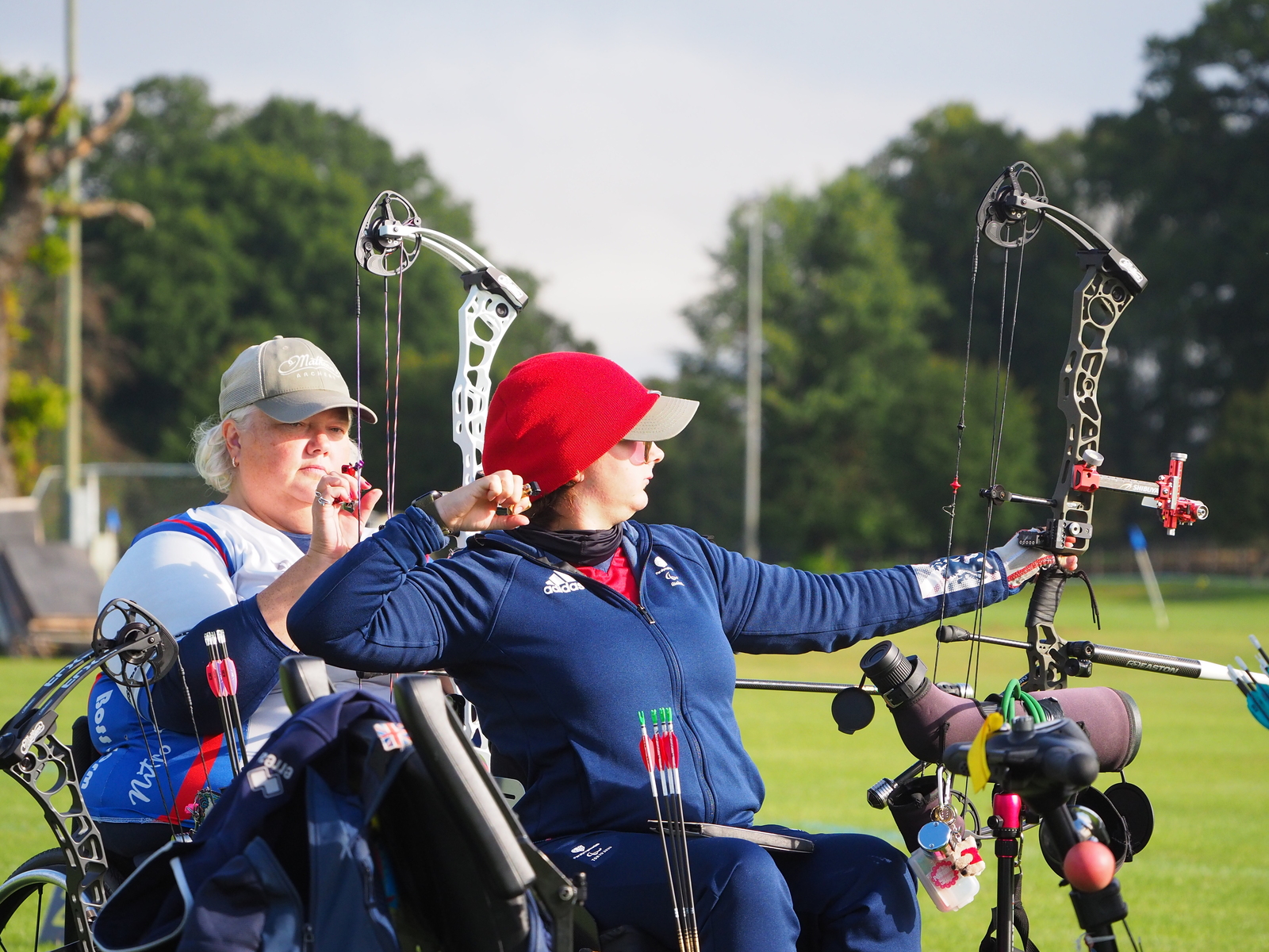 Two para archers on the shooting line at a competition