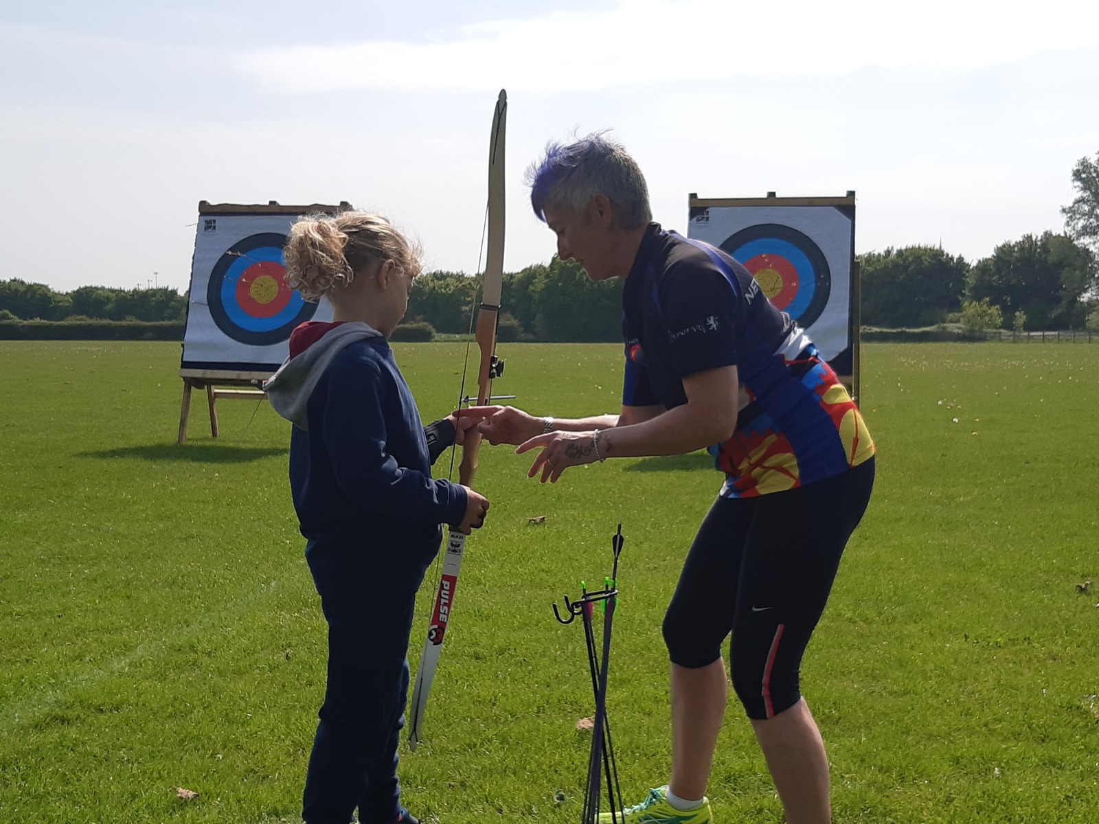 Coach and archer on the shooting line